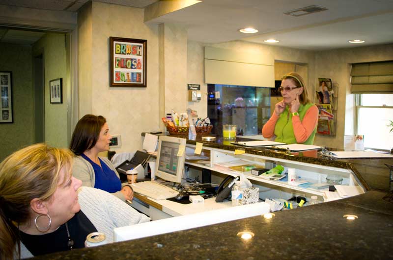 The office staff talking with patient at Cramer Dental in Blue Bell, PA  