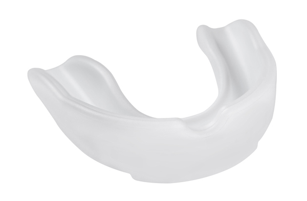 Opaque white plastic mouthguard on a white background from Cramer Dental in Blue Bell, PA